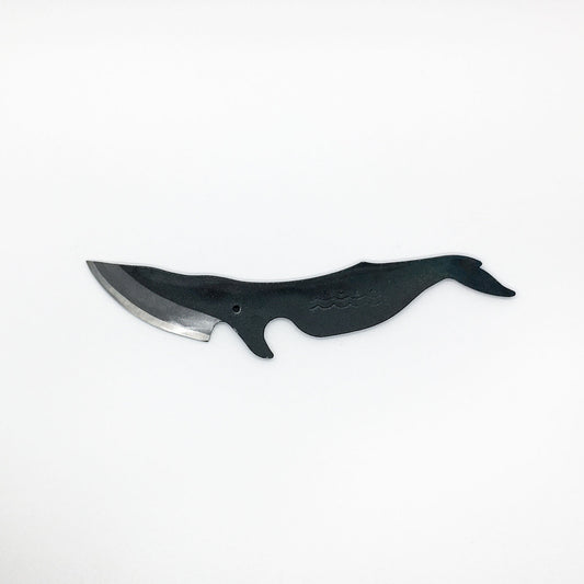 a carbon steel hand knife in the shape of a minke whale