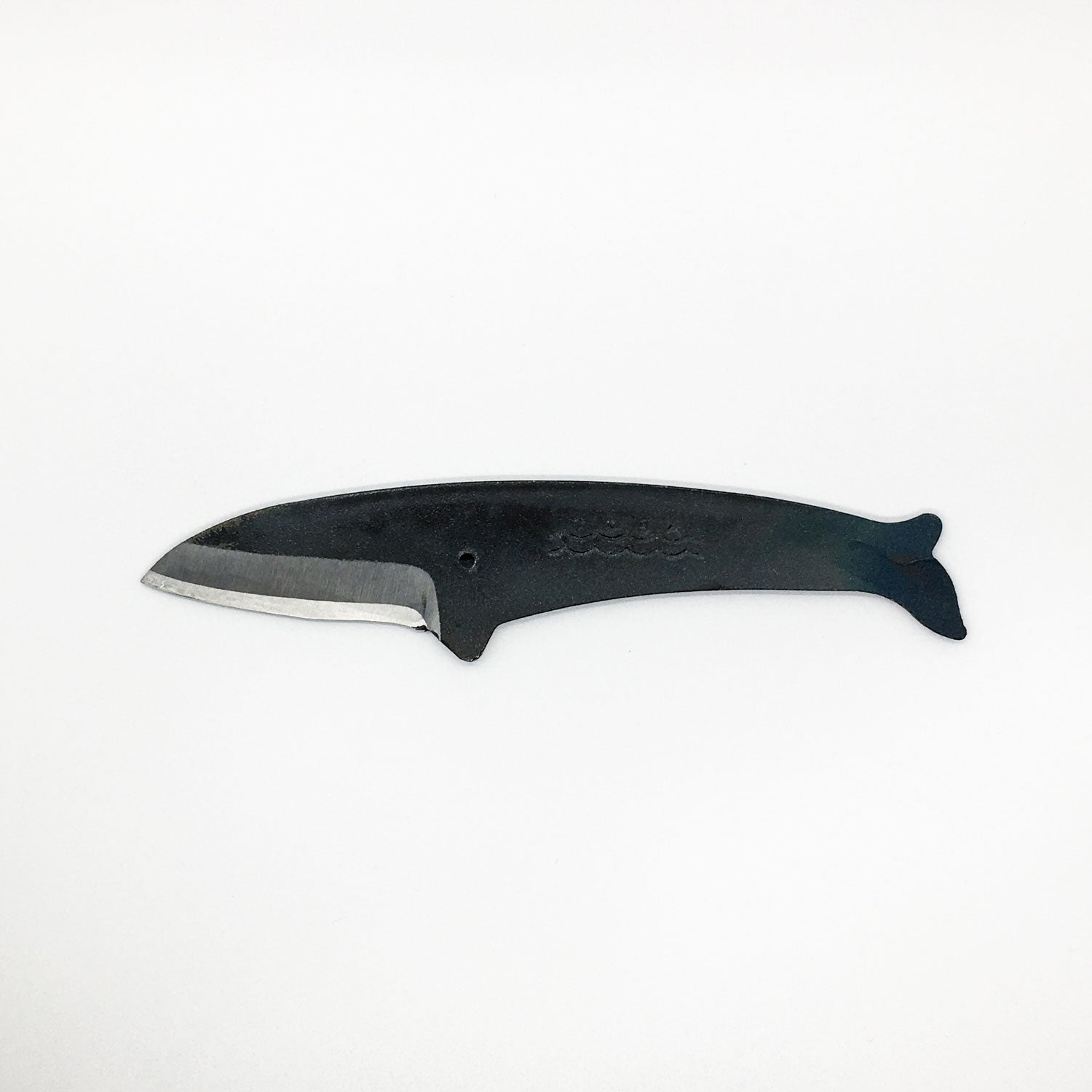 a carbon steel hand knife in the shape of a fin whale