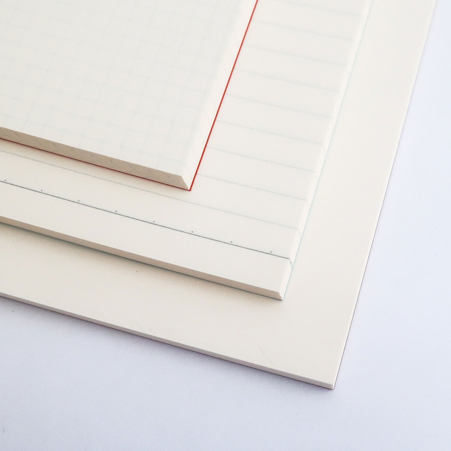 cream colored interior notebook pages that come gridded, ruled and plain