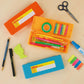 desktop view of penco storage container pen case in orange, yellow and light blue showcasing color variations and open and closed cases. open pen case includes pens, pencil, masking tape and ruler surrounded by Penco prime timber mechanical pencil as well as blue glue and scissors.